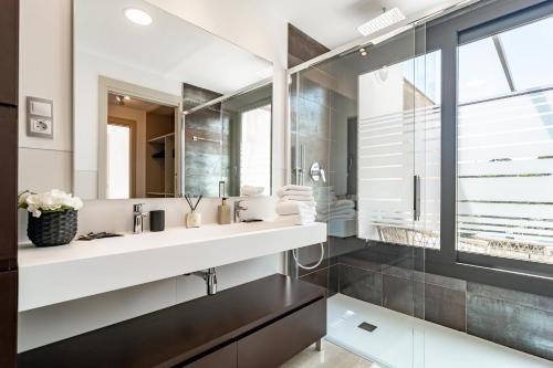 a bathroom with a sink and a mirror at GG- Modern townhouse, families & couples only in Marbella