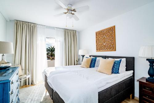 a bedroom with a large bed with a ceiling fan at MA - Elegant Apartment with Sea views in Marbella