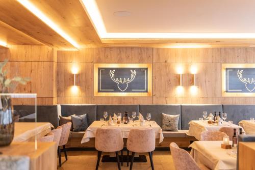 a restaurant with tables and chairs in a room at Der WALZL in Innsbruck