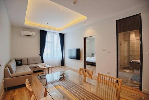 a living room with a couch and a table at Play Poshtel & Cafe' in Krabi town