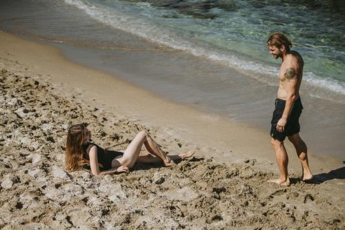 a man and a woman laying on the beach at Infinity Blue Boutique Hotel & Spa - Adults Only in Hersonissos