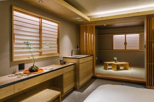 a bathroom with a bed and a sink and window at Higashiyama Shikikaboku in Kyoto