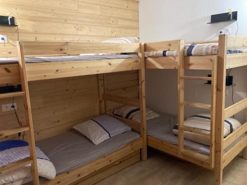 a bunk bed room with three bunk beds in it at Great 8-pax ski-in ski-out apartment in Tignes Val Claret in Tignes