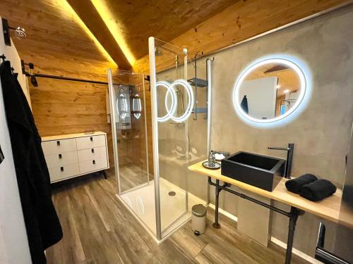 a bathroom with a shower and a sink and a mirror at Hirschbachwinkel - fewo-badhindelang in Bad Hindelang