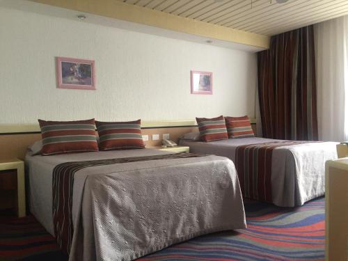 Postel nebo postele na pokoji v ubytování Hotel Fleming