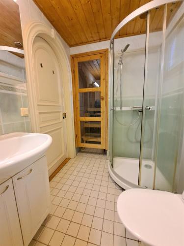 a bathroom with a shower and a sink and a tub at Lomasärkkä1 in Kalajoki