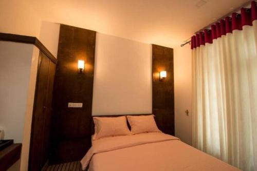 a bedroom with a bed and a window with red curtains at Ovitiyas Bandarawela in Bandarawela
