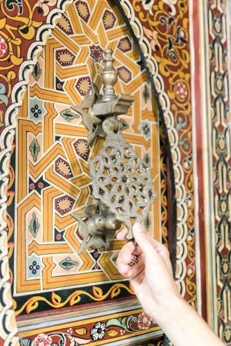 a person is holding a metal object on a wall at Hotel Moroccan House Casablanca in Casablanca