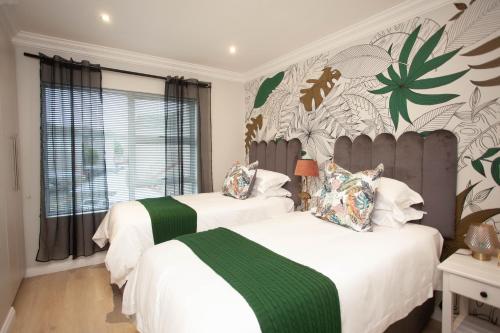 a bedroom with two beds and a large window at The view 42 in Jeffreys Bay