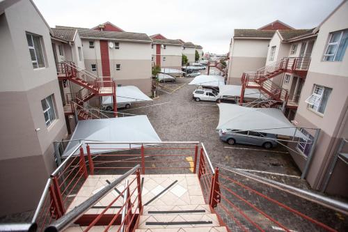 an aerial view of a parking lot with cars and buildings at The view 42 in Jeffreys Bay
