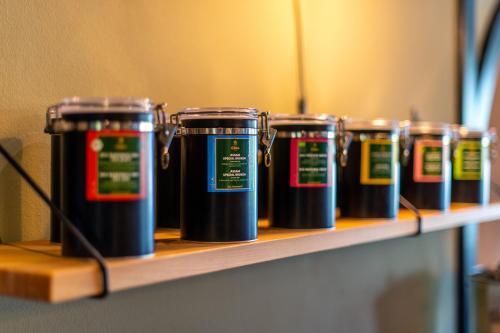 a row of black coffee cups on a shelf at Diehls Hotel in Koblenz