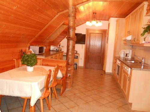 a kitchen and dining room with a table and chairs at Familienbauernhof Imitz, Ferienwohnung in Spital am Pyhrn