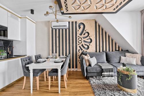 a living room with a table and a couch at Aparthotel Góralski Spa 2 in Białka Tatrzanska