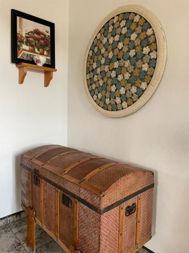 a painting on a wall next to a chest against a wall at Casa Rural Los Caleros in Fondón