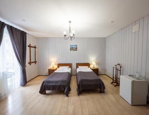 a hospital room with two beds and a chandelier at Villa Shale MarSo in Bukovel