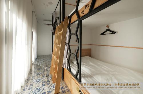 a room with two bunk beds in a room at Journey Hostel in Tainan