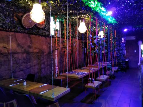a row of tables in a restaurant with lights at Waterside Lodge CC in Piet Retief