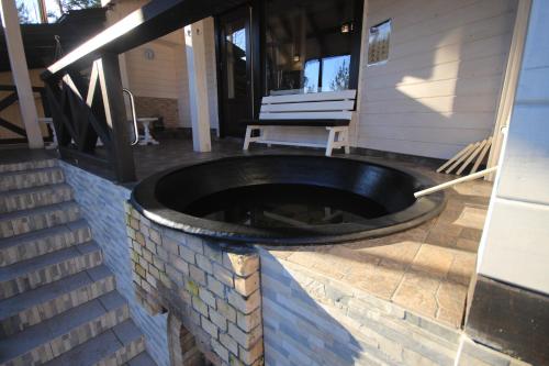 a fire pit on the back of a house at Villa Medova in Kosiv