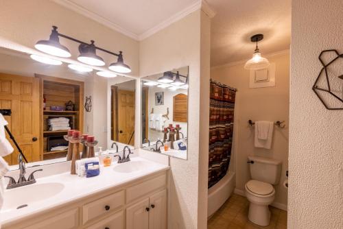 a bathroom with a sink and a toilet and a mirror at Sunsets at Summit 108b, free WI-FI, parking and AC in Snowshoe