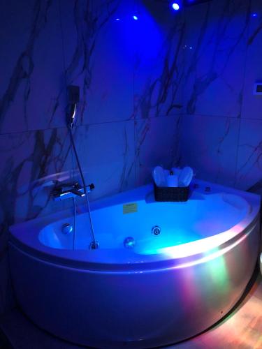 a bath tub in a room with a blue light at Alba Camere in Palermo