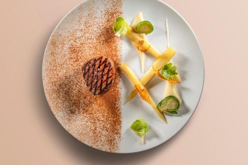 a plate of food on a white plate at Jiva Hill Resort - Genève in Crozet