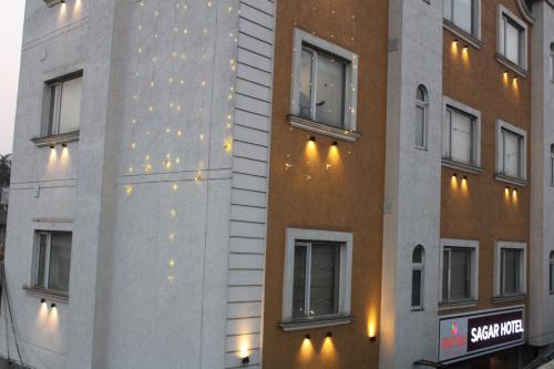 a building with lights on the side of it at Sagar Hotel JUST 5 MIN FROM GOLDEN TEMPLE in Amritsar
