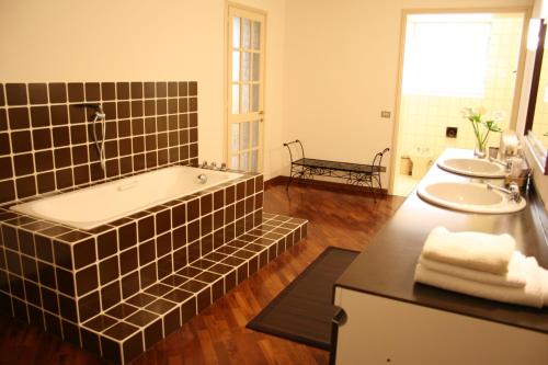 a bathroom with two sinks and a bath tub at Casa Margherita in Mantova