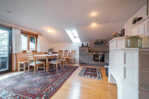 a kitchen and dining room with a table and chairs at D`Alpenapartments Bezau in Bezau