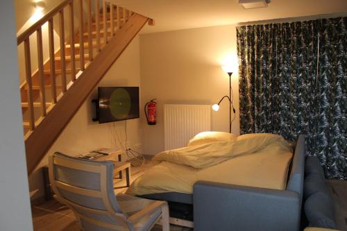 a bedroom with a bed and a desk and a staircase at De Panne - Adinkerke - 't Voetbrugsje comfortabele nieuwbouw in De Panne