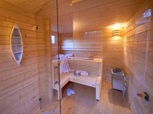 a wooden bathroom with a sink and a shower at Strandschlösschen Sellin - Haushälfte 2 in Ostseebad Sellin