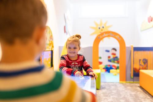 a little girl playing with a toy in a room at Der WALZL in Innsbruck