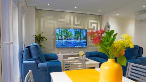 a living room with blue couches and a tv at Spacious Modern Family Apartment - Centre & Near Beach in Alicante