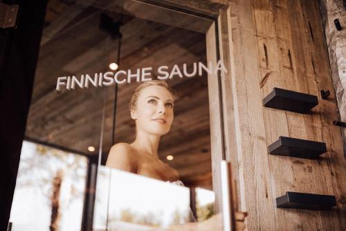 a woman in a window of a boutique at Panoramahotel Am Sonnenhang in Tirolo
