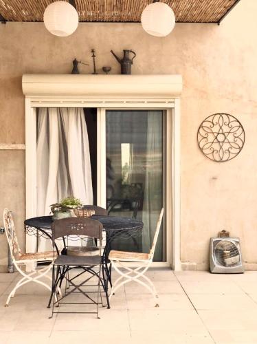 a black table and chairs on a patio at יעלת חן Ya'alat hen in Yeroẖam