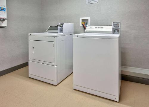 two white refrigerators sitting next to each other in a room at La Quinta by Wyndham Little Rock - Bryant in Bryant