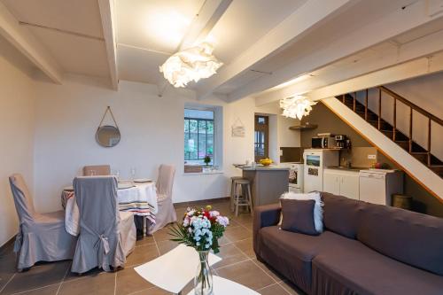 a living room with a couch and a table at La Grand Voile - maison 4 chambres vue mer - plage à 900 m in Saint-Pol-de-Léon