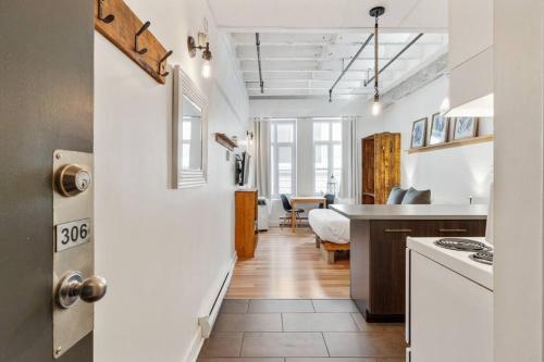 a kitchen with a hallway leading to a living room at INITIAL - MEMORY FACTORY - Centre-Ville de Québec in Quebec City
