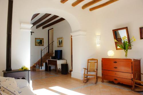 a living room with a dresser and a desk at Finca Cavea in Caʼs Concos