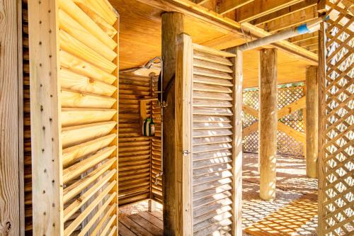 two images of a wooden house with a door at Pelican's Hideaway in Folly Beach