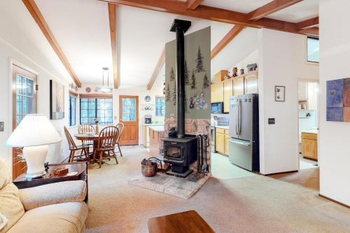 a living room with a stove and a kitchen at Hikers Haven in Arnold