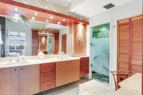a bathroom with two sinks and a large mirror at Waterfront Wonder in Islamorada
