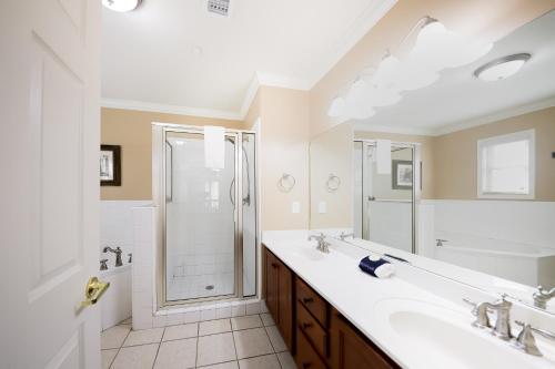 a white bathroom with two sinks and a shower at The Bears Den in Helen