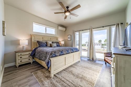 a bedroom with a bed and a ceiling fan at Pacific Breeze in Gold Beach