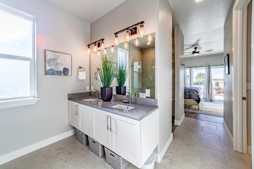 a white bathroom with a sink and a mirror at Pacific Breeze in Gold Beach