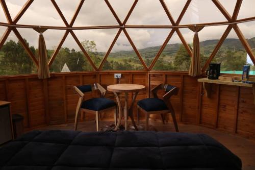 a room with a table and chairs and a window at Villa Rebequita in Villapinzón