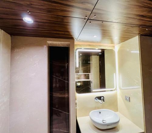 a bathroom with a white toilet and a mirror at The Prime Delhi - Luxe Collection Hotel in New Delhi