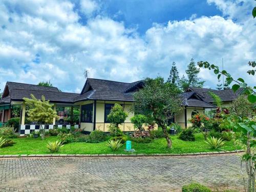 an exterior view of a house with a garden at Designer Villa Osaka in Puncak