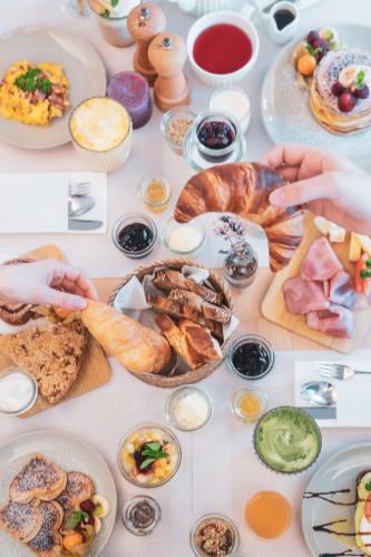 a table filled with lots of different types of food at la belle vue Boutique Hotel & Café in Spiez
