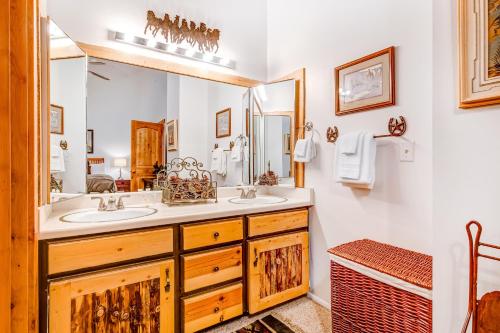 uma casa de banho com 2 lavatórios e um espelho grande em Ski Alta em Sandy