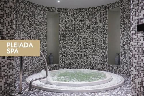 a bathroom with a tub with a sign that reads pelapa spa at Pleiada Boutique Hotel & Spa in Iaşi